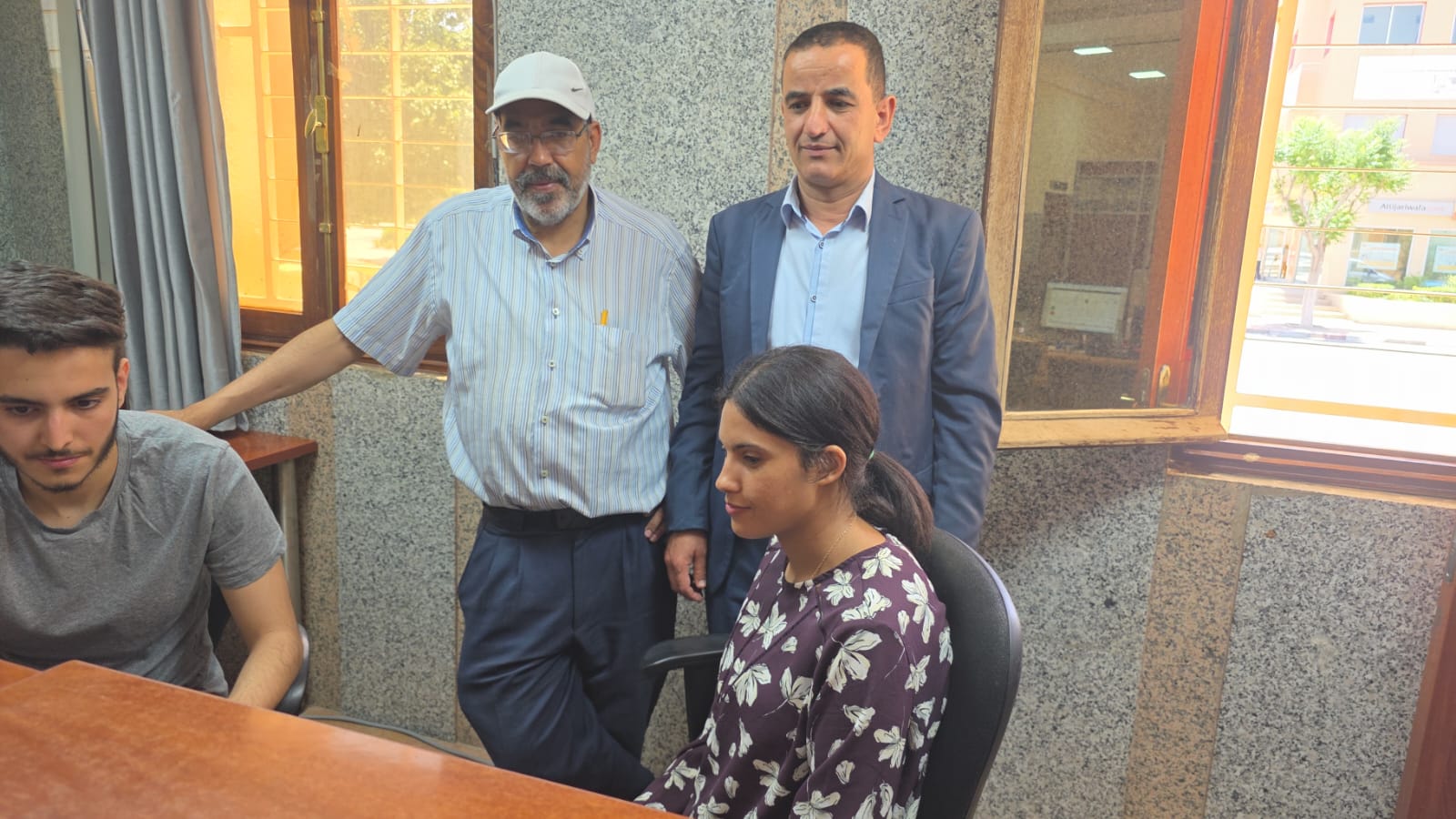Sanad Idari and office staff reviewing GeoMiz on screen