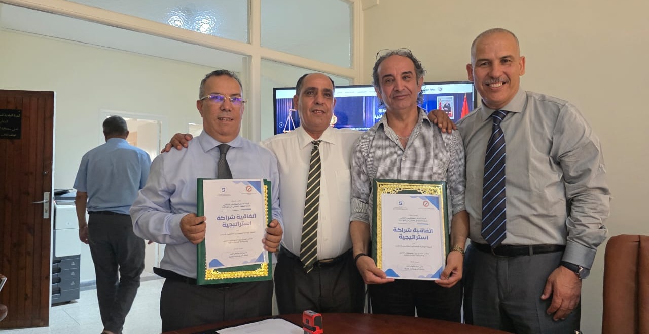 Representatives holding the framed strategic partnership certificates