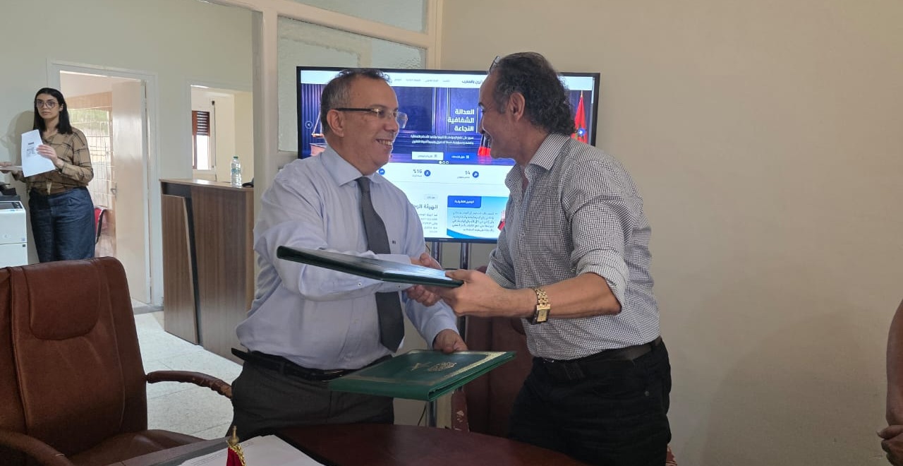 Representatives of the Order and Sanad Idari exchanging the signed partnership folders
